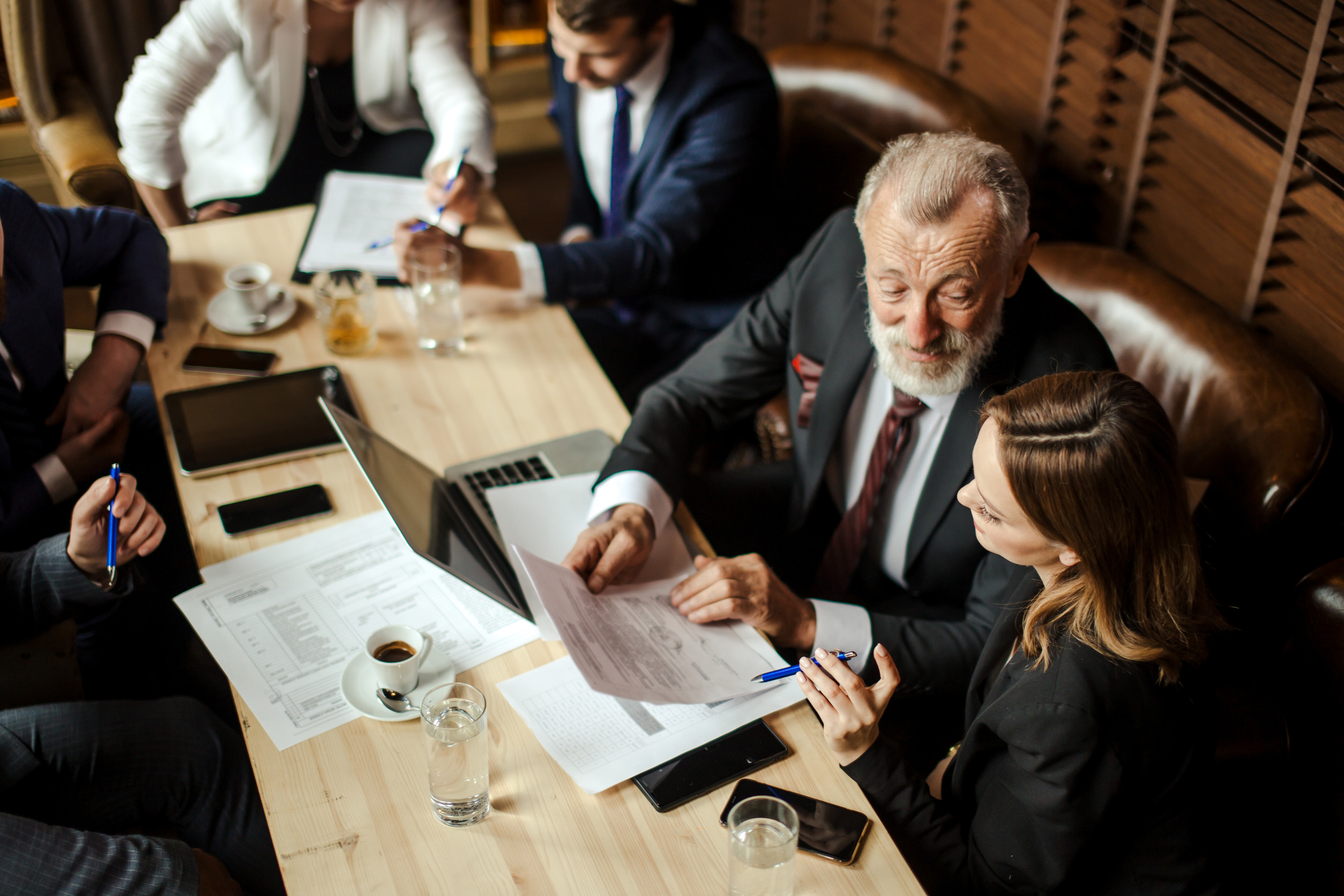 Construction firm executives reviewing leadership succession and recruiting strategy in a planning session.